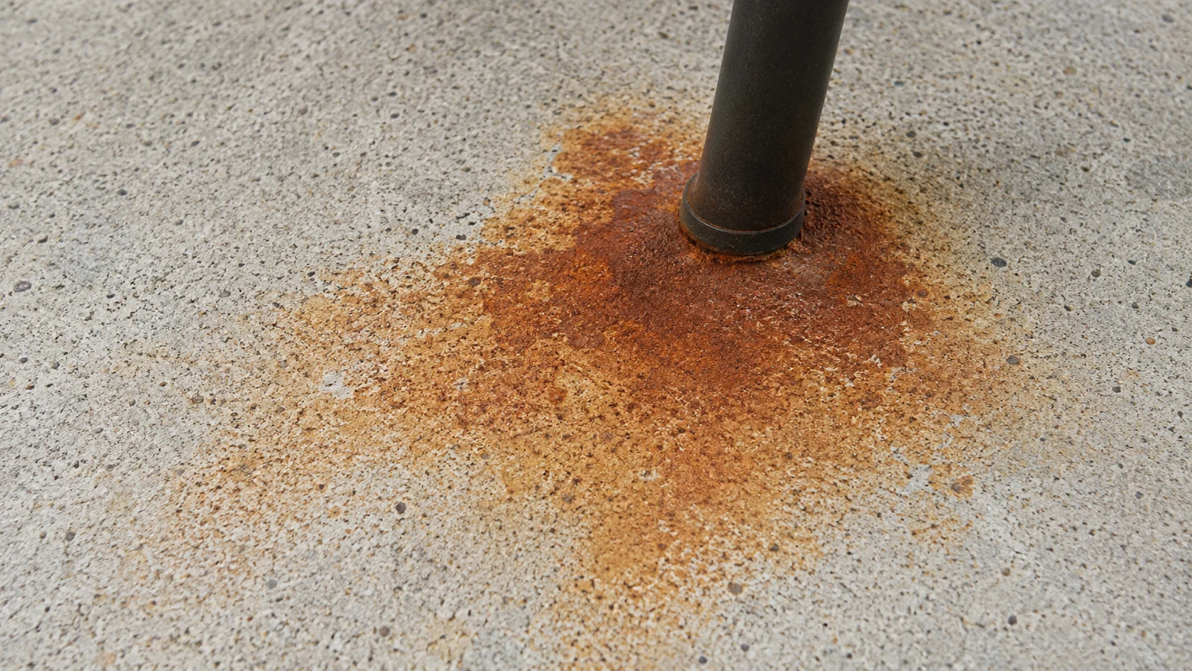 Rust stain on a concrete patio left by metal furniture